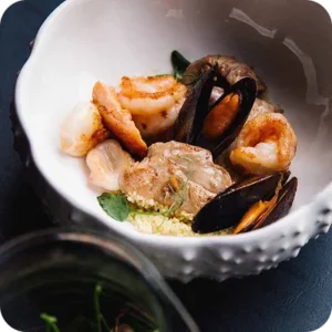 Shrimp and mussels served in a white bowl