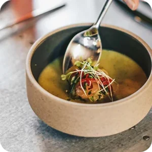 A soup course topped with microgreens