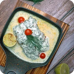 A creamy baked dish with tomatoes and dill in a cast-iron pan