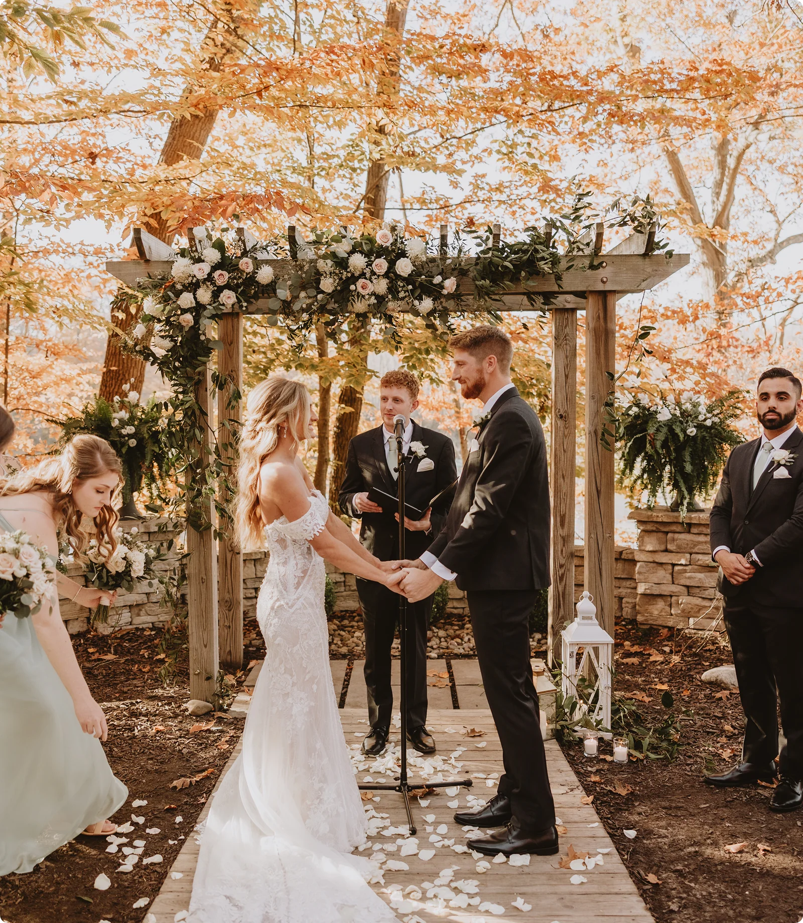 Couple exchanging vows under a floral arch