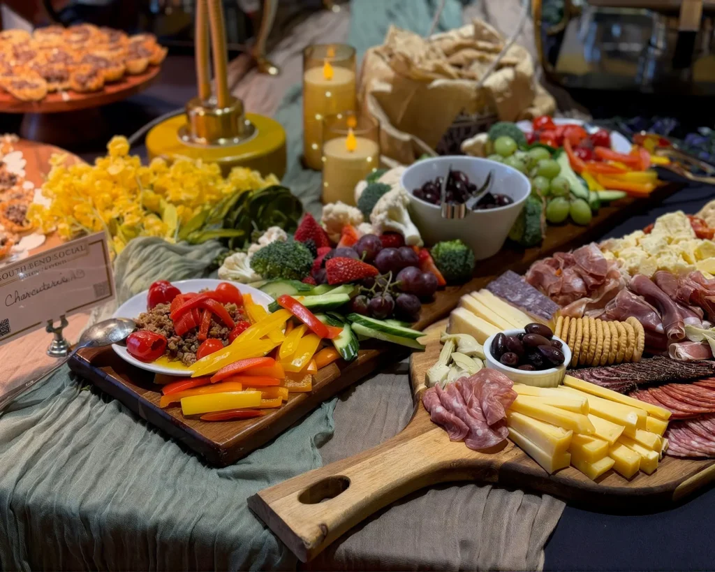 Grazing table of charcuterie, cheeses and fruit on wooden boards