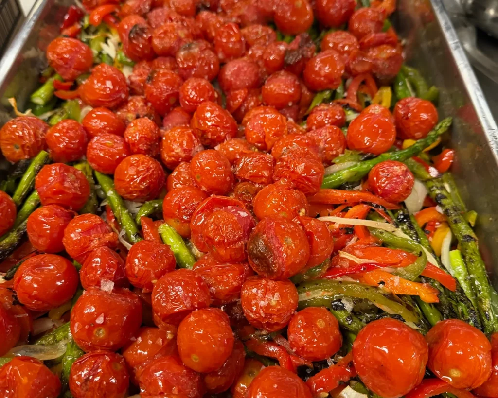 Tray of roasted cherry tomatoes and asparagus