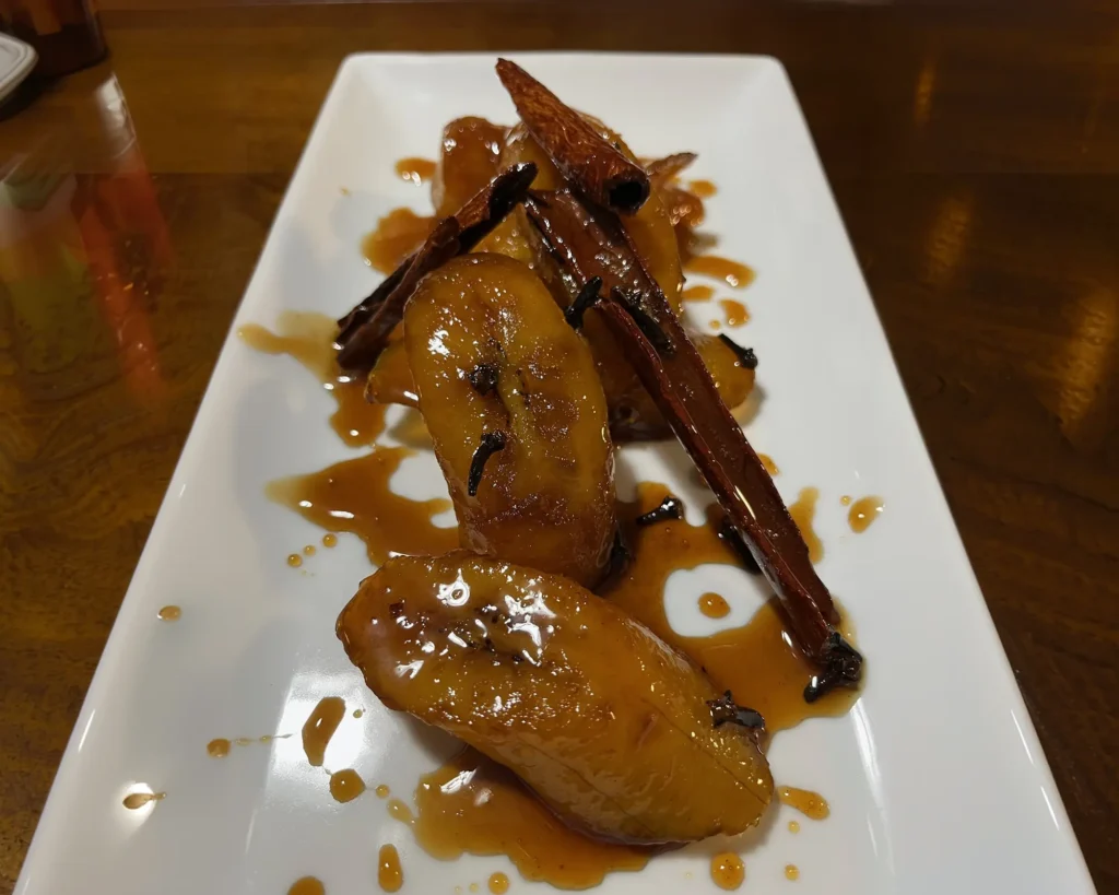 Plated poached pear dessert with caramel sauce
