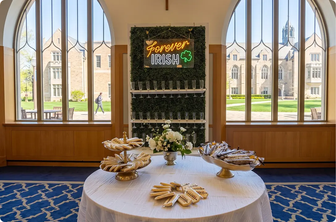 Round table with a floral centrepiece in a hall with arched windows