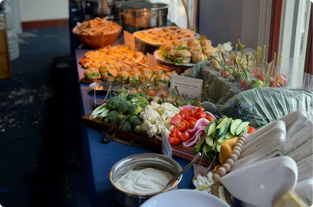 Buffet line of crudites, charcuterie and dips at a catered event