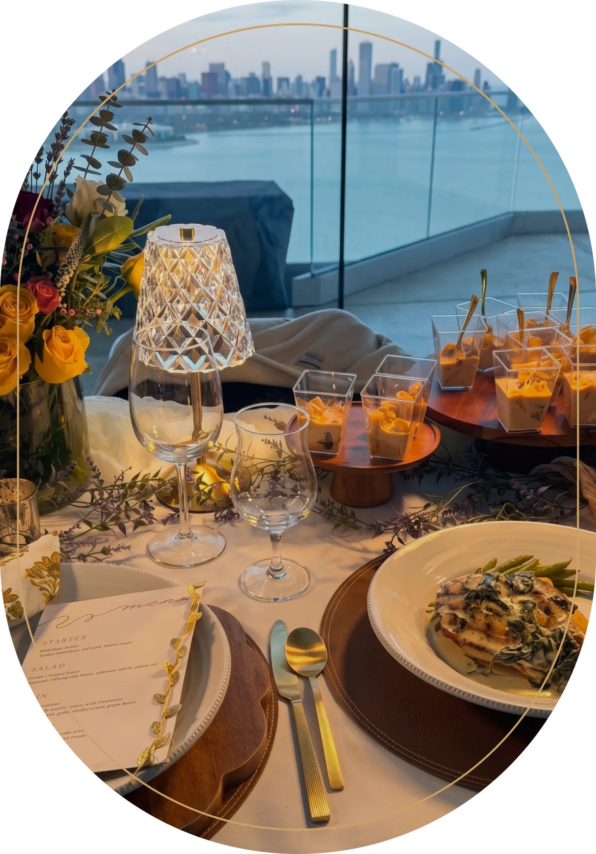 Outdoor table set with lanterns and cocktails beside the water at dusk